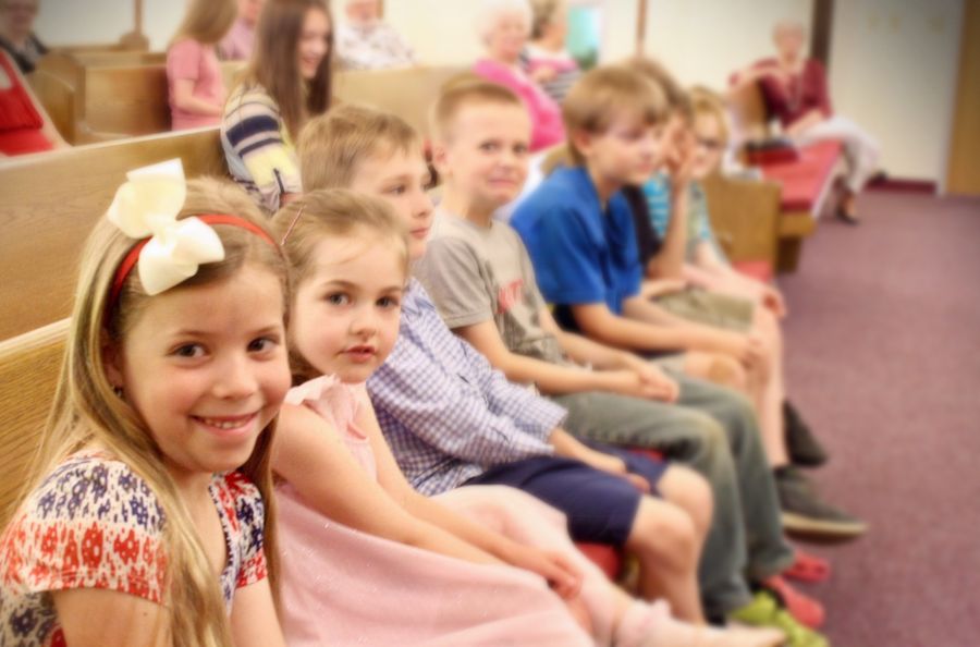 Children sitting together in the pews